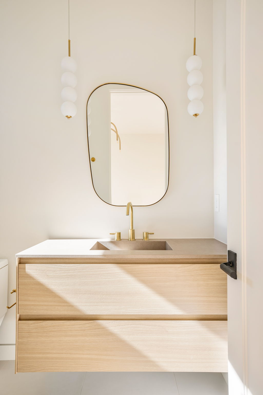The Alder House guest bath vanity with bubble glass pendant lighting