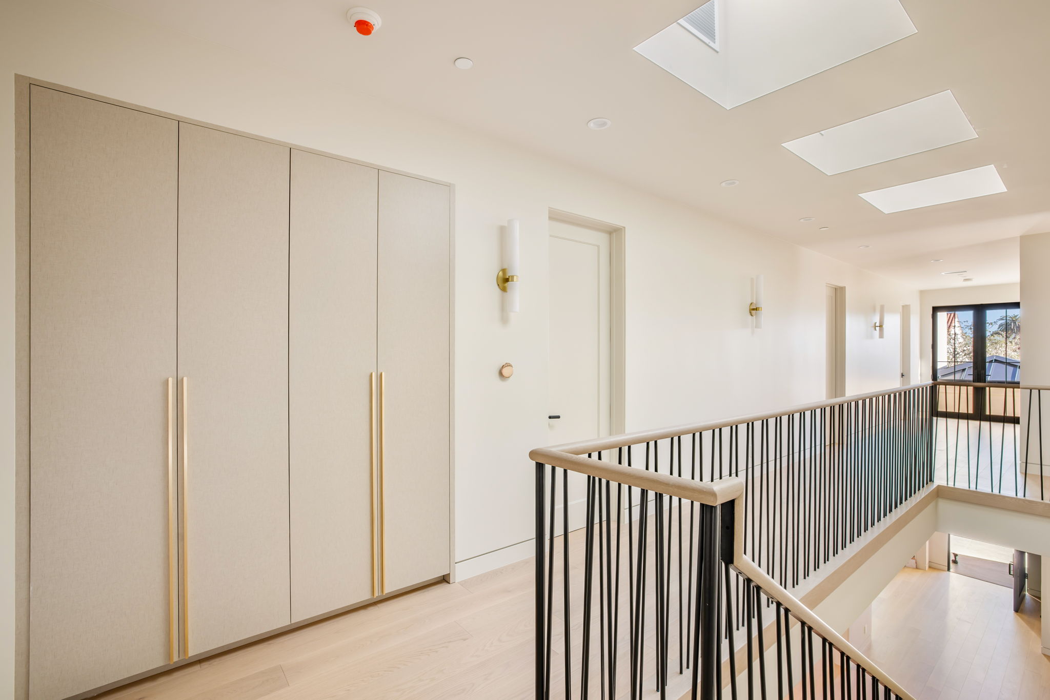 The Alder House upstairs hallway with skylights and built-in wardrobe