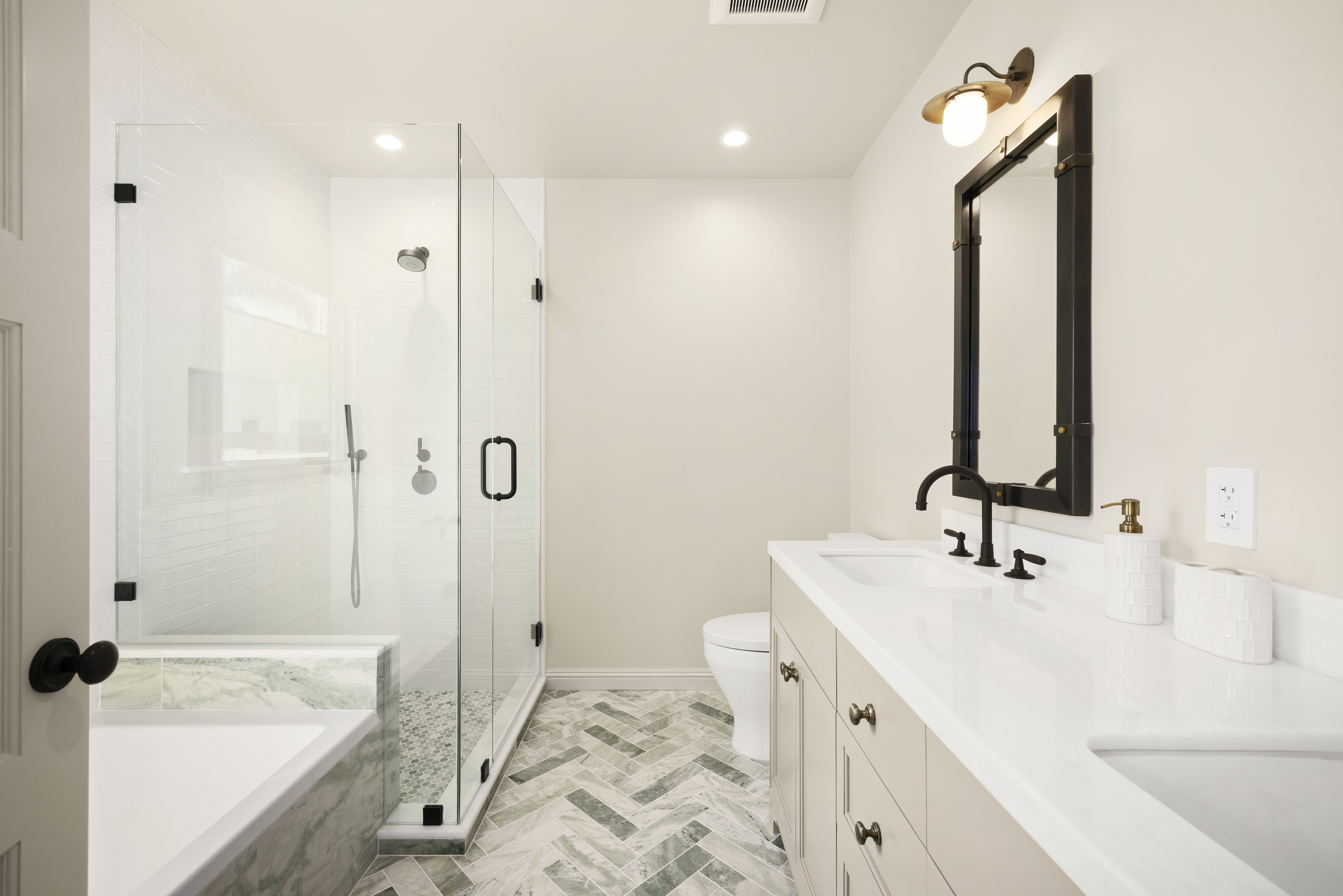 Casa Lista primary bath glass shower with herringbone floor