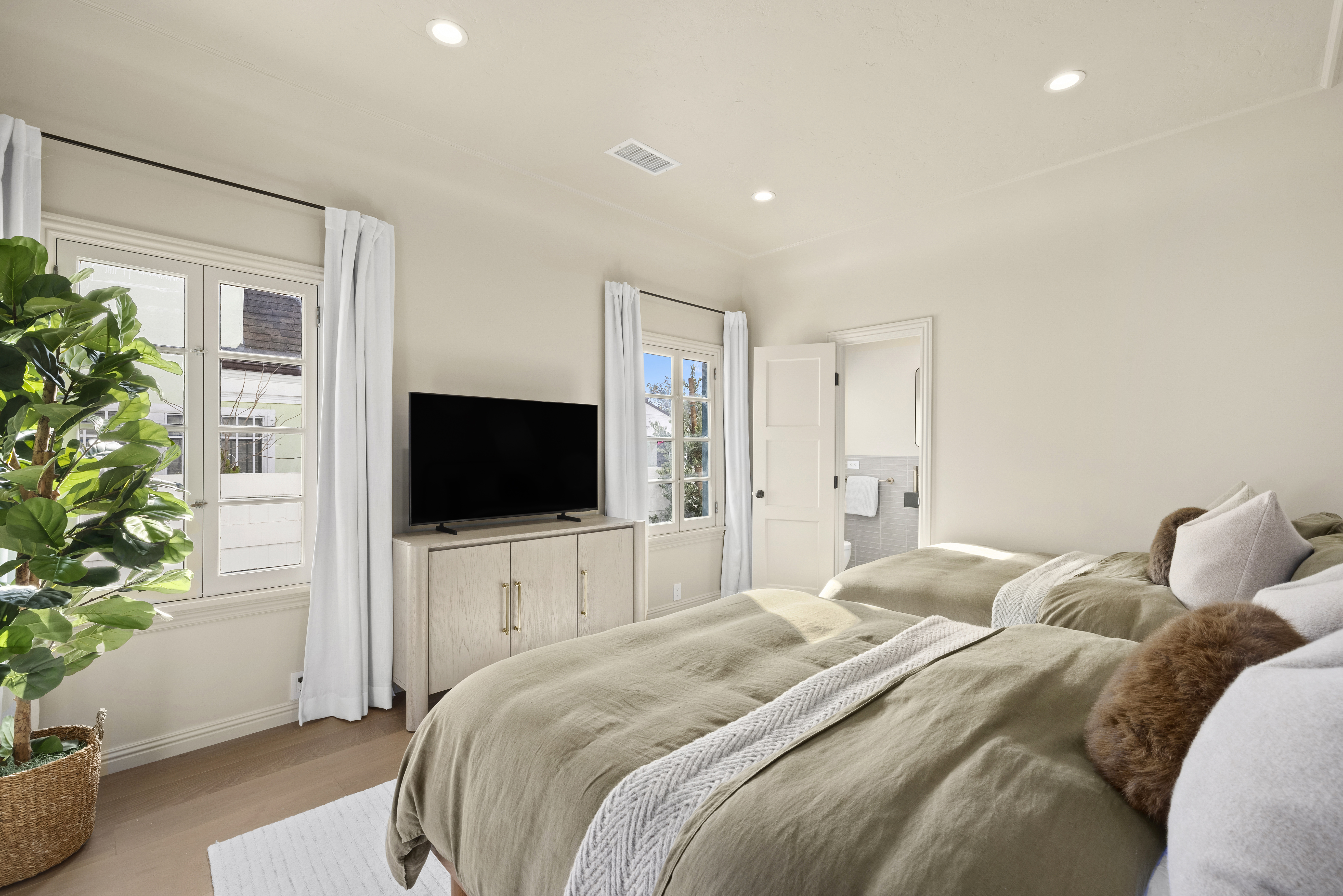 Casa Lista primary bedroom with twin beds and olive bedding