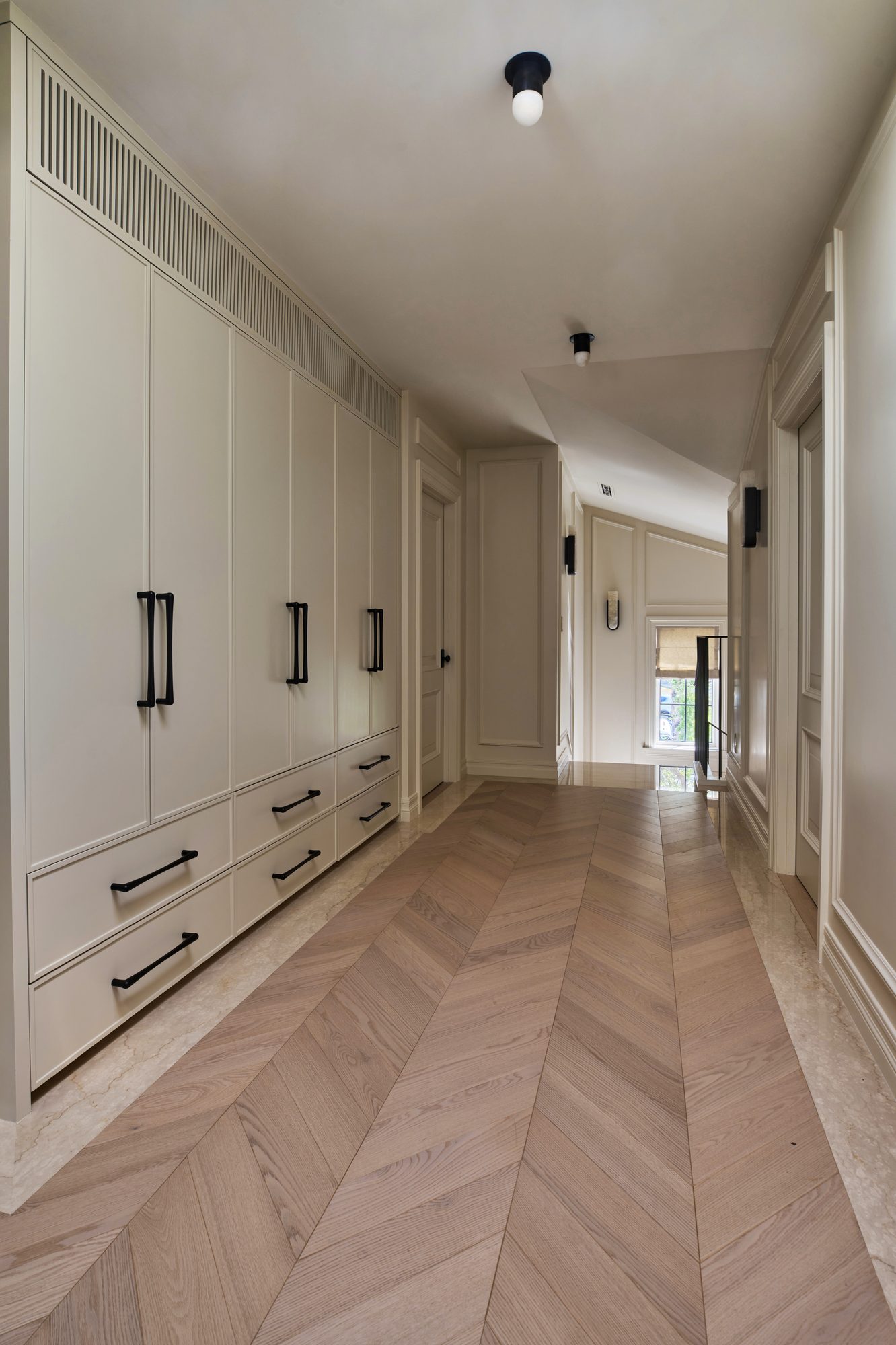 Casa Marfil upstairs hallway with chevron flooring