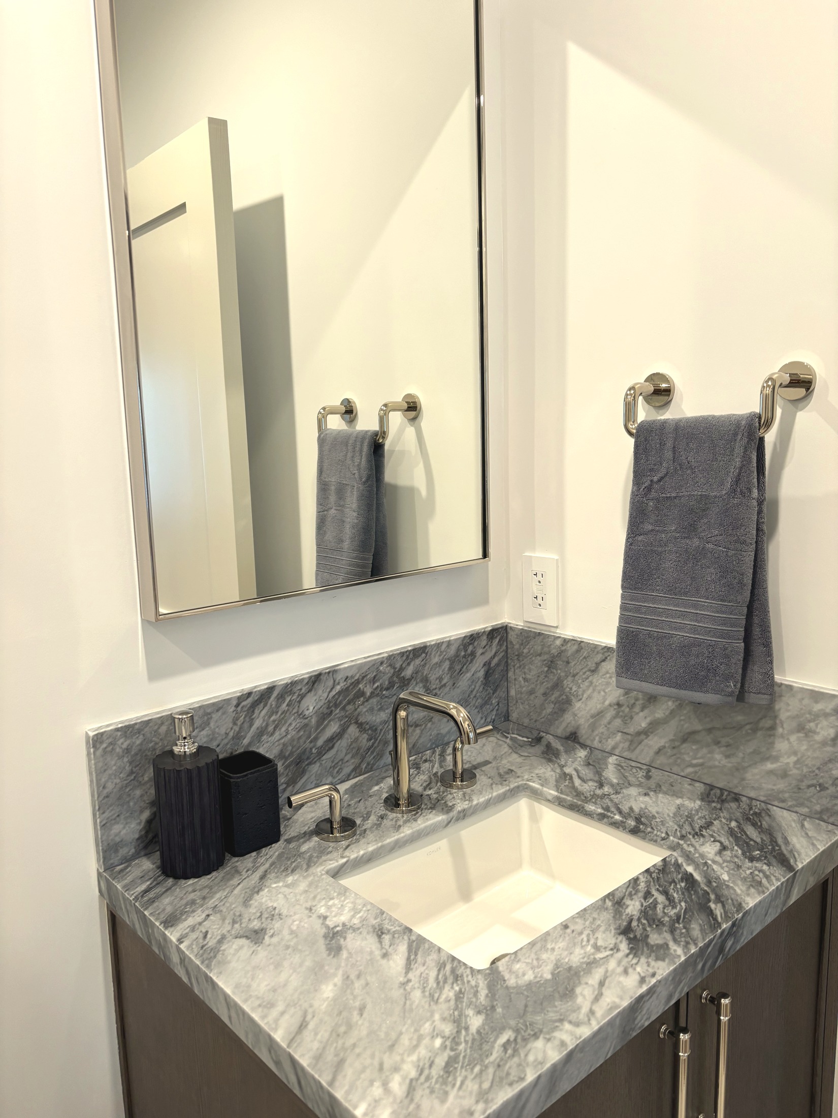 The Coach House bathroom vanity with marble counter and chrome fixtures