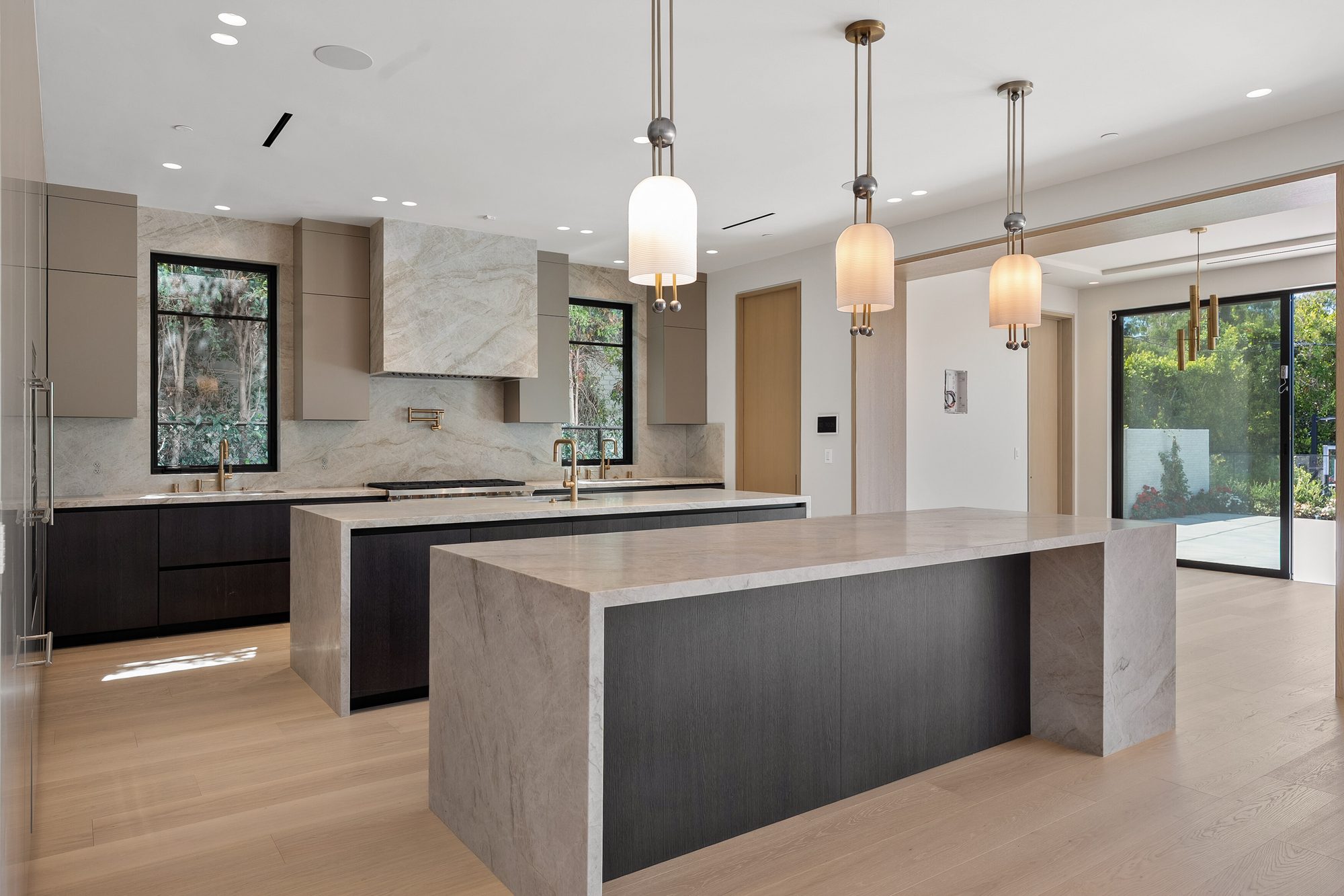 The Form House kitchen opening to pool and yard