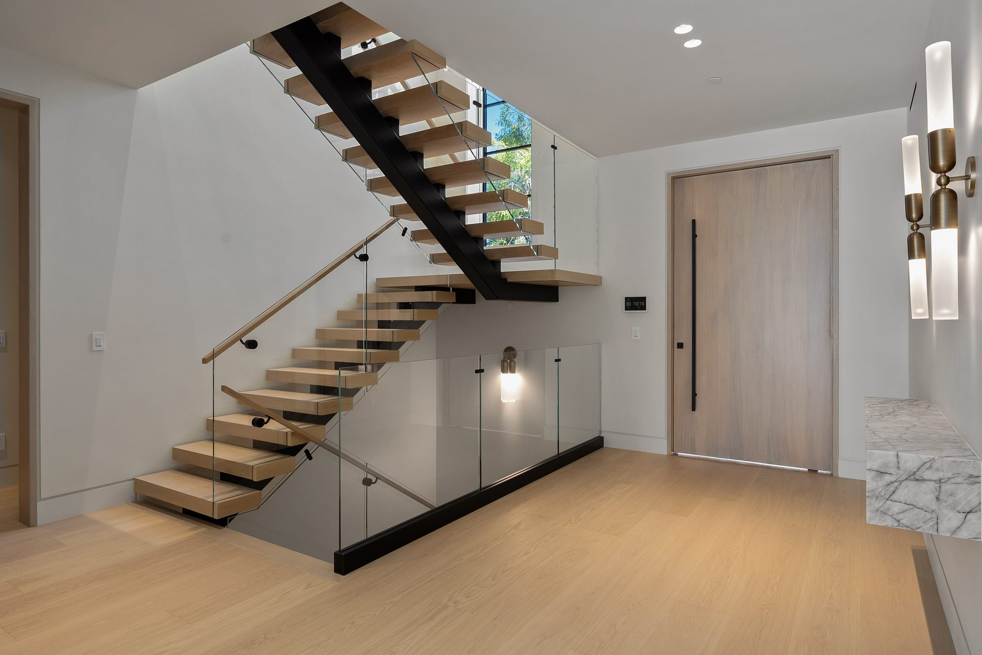 The Form House dark powder room with glass tube pendants