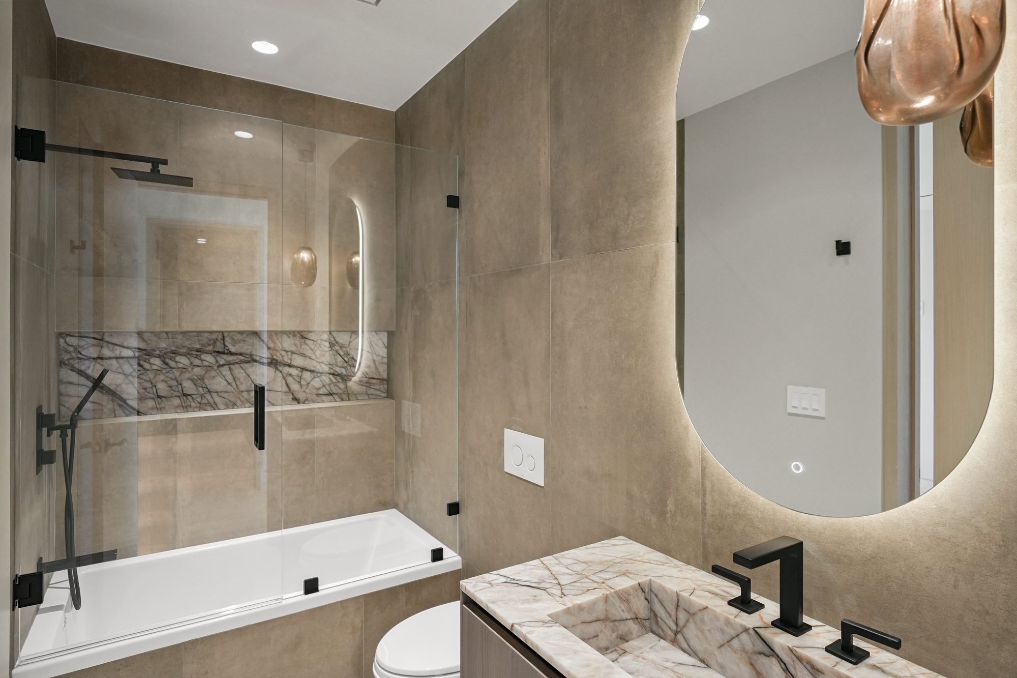 The Form House primary bath long vanity with oval mirrors