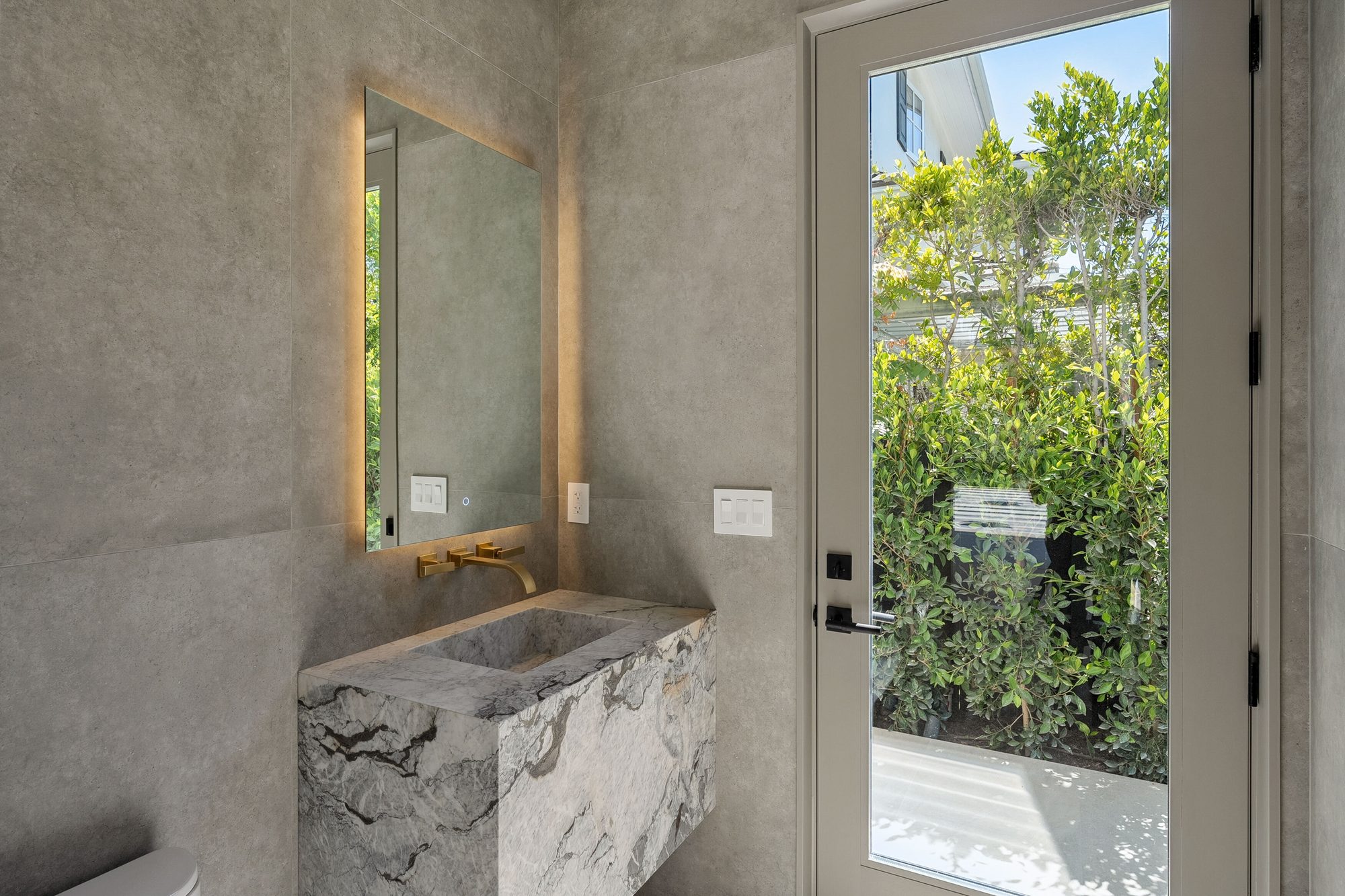 The Form House wet bar with mirrored shelving and sculptural pendant light
