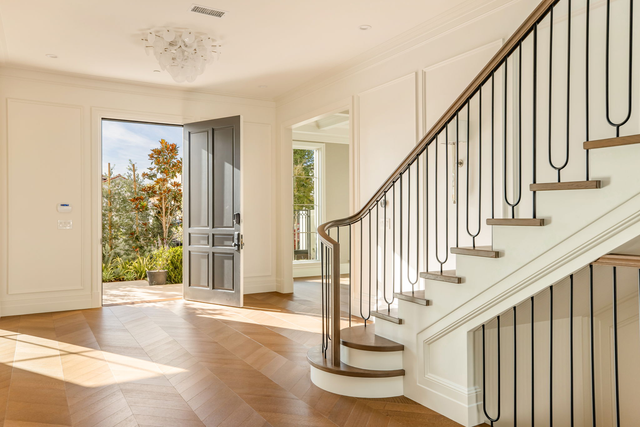 The Magnolia House entry with open front door and staircase