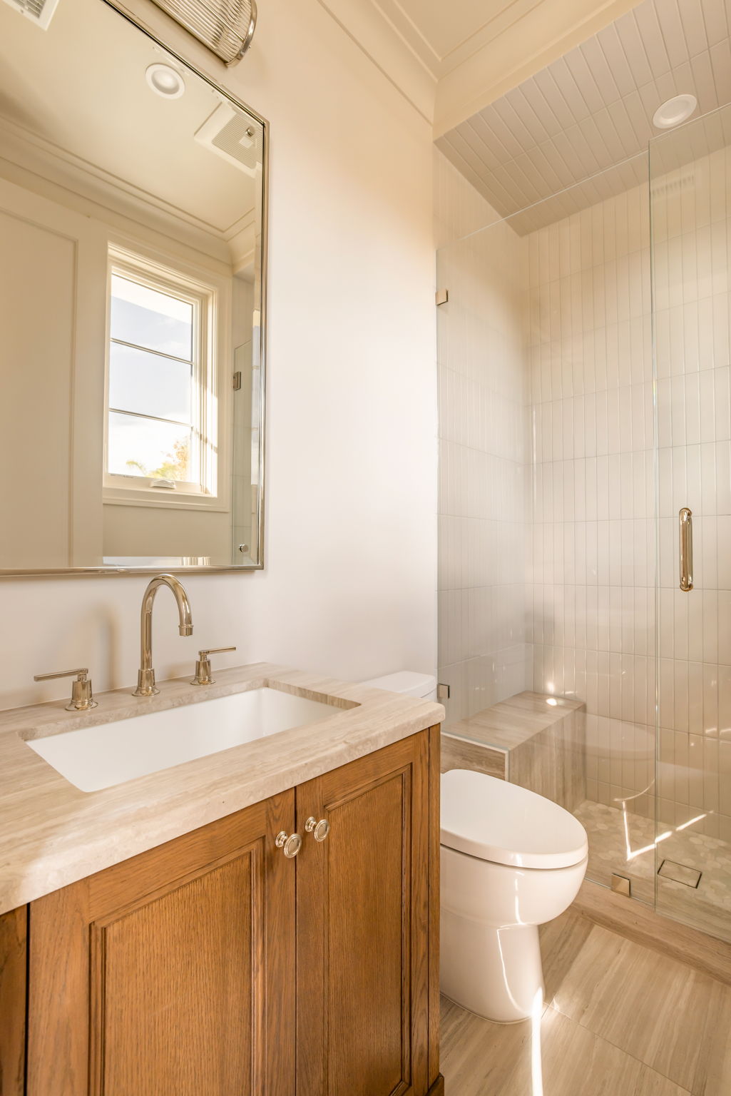 The Magnolia House powder room with glass shower and wood vanity