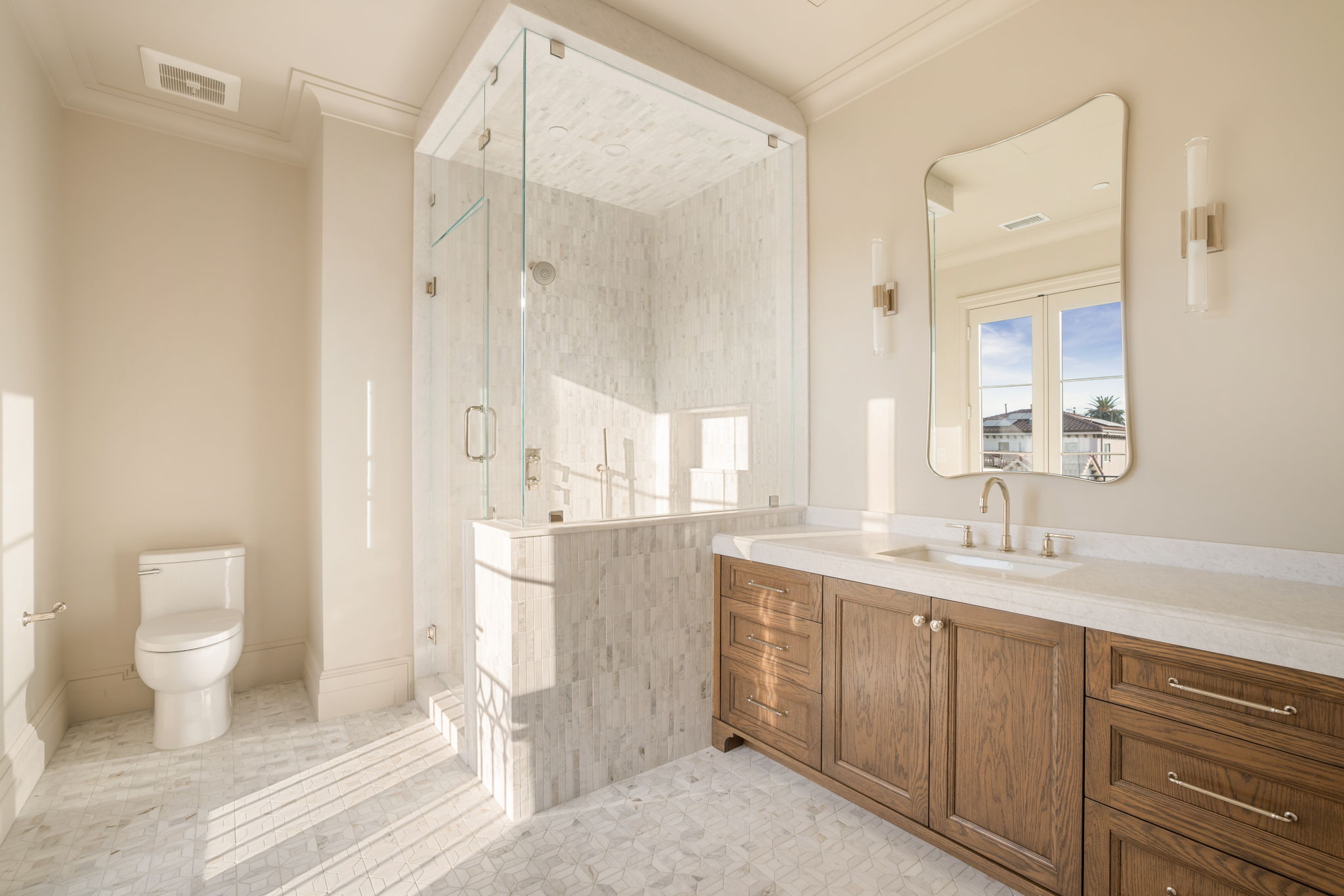 The Magnolia House primary bath with corner glass steam shower