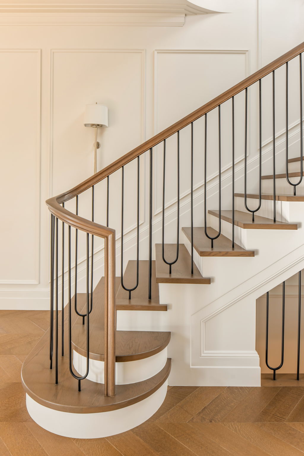 The Magnolia House curved staircase with iron railing detail