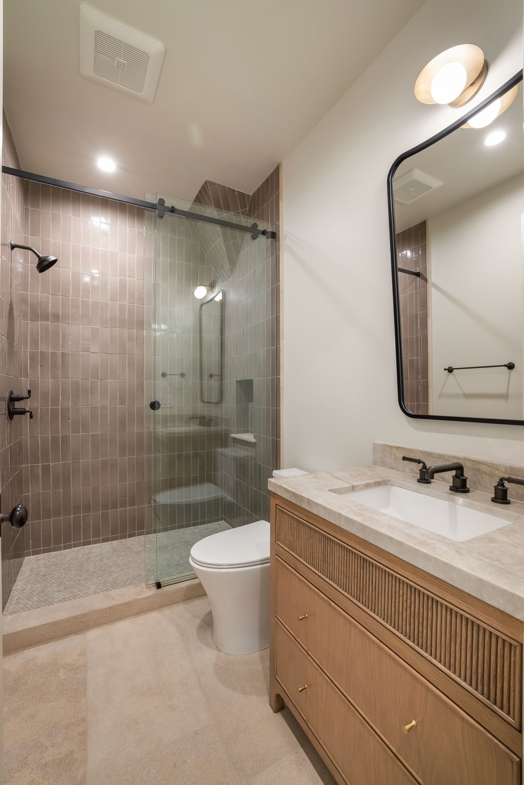 Storybook House guest bathroom with pink tile shower