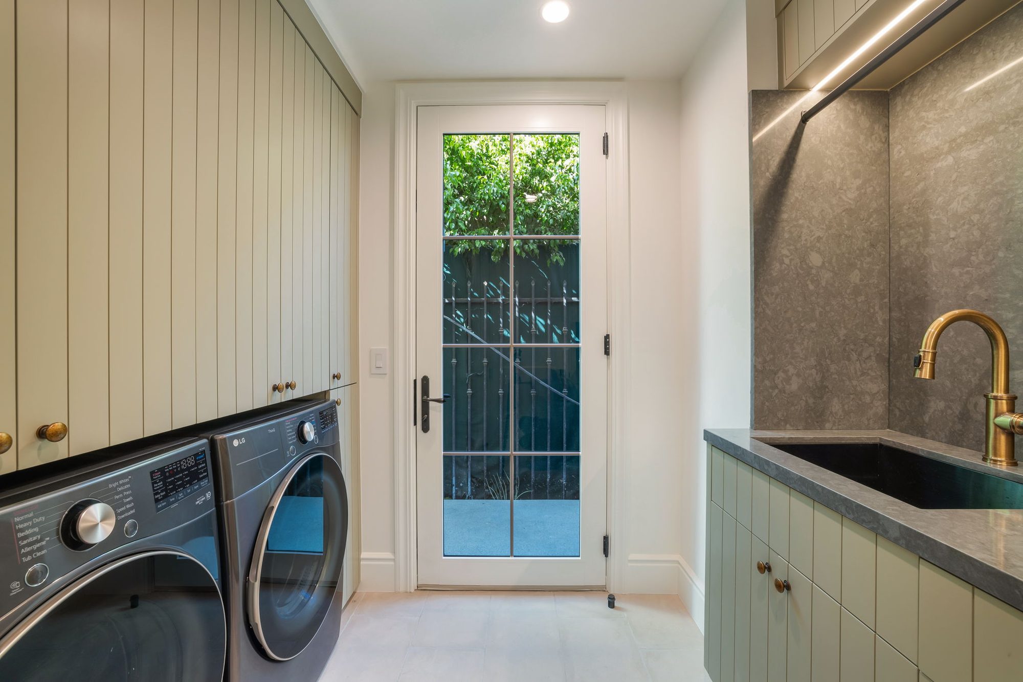 Storybook House laundry room with brass fixtures