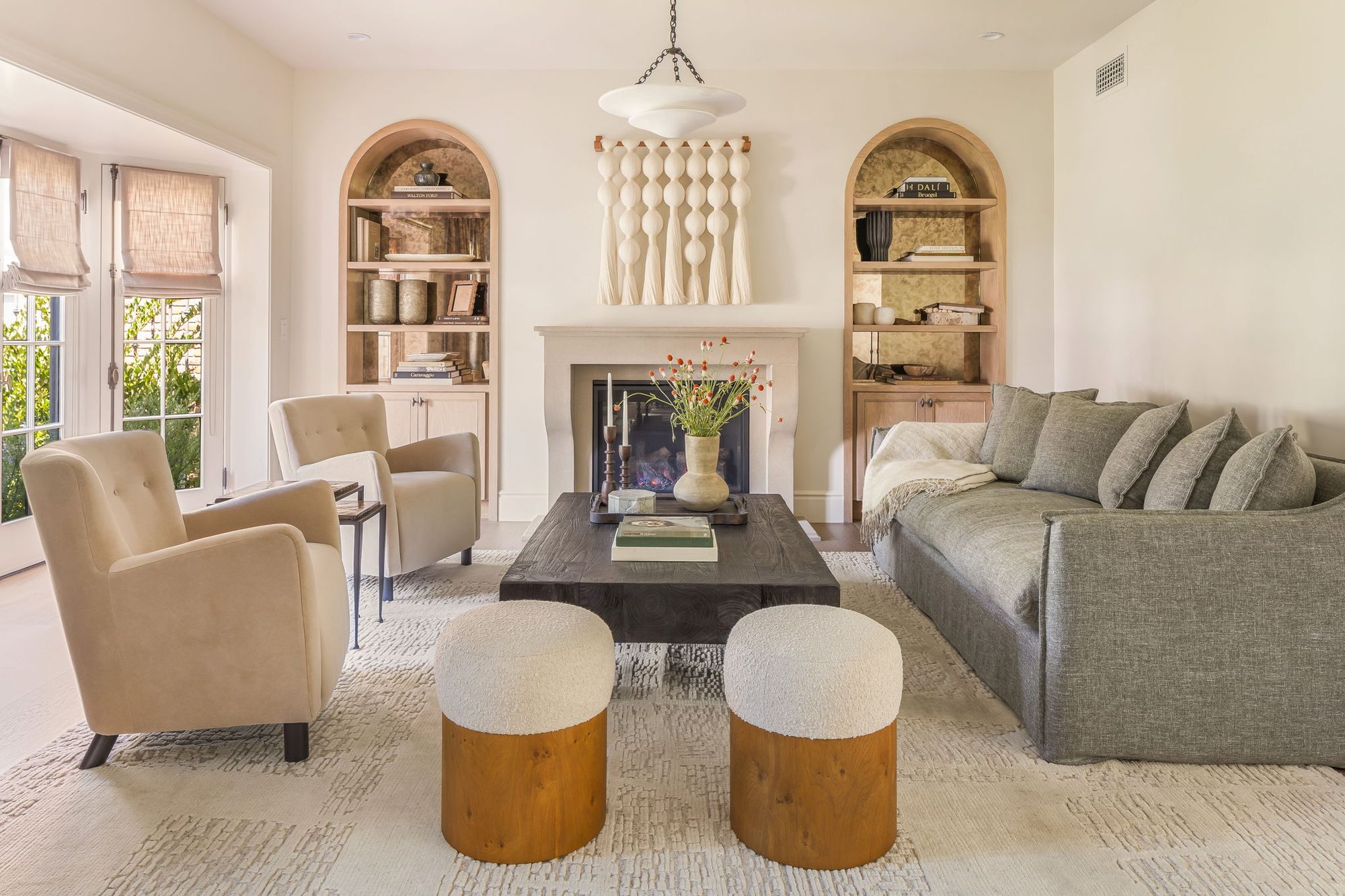 Storybook House living room with arched bookshelves and fireplace