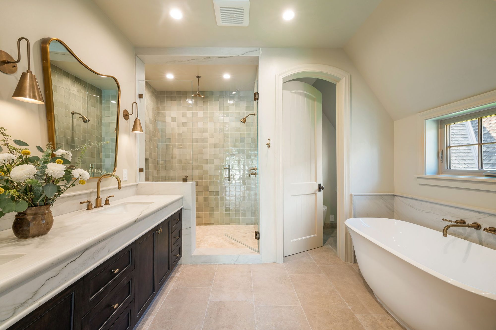 Storybook House primary bath with green tile shower and soaking tub