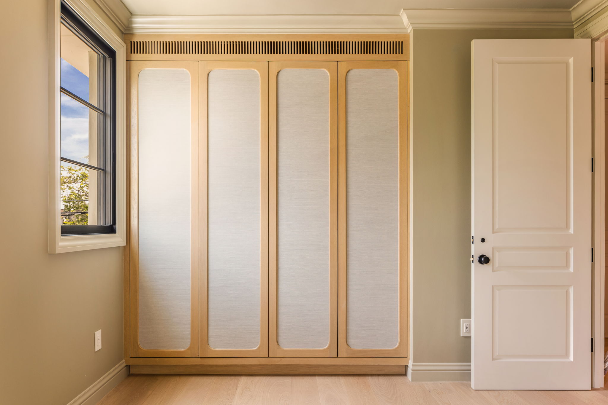 The Thistle House bedroom built-in wardrobe with fabric-paneled doors
