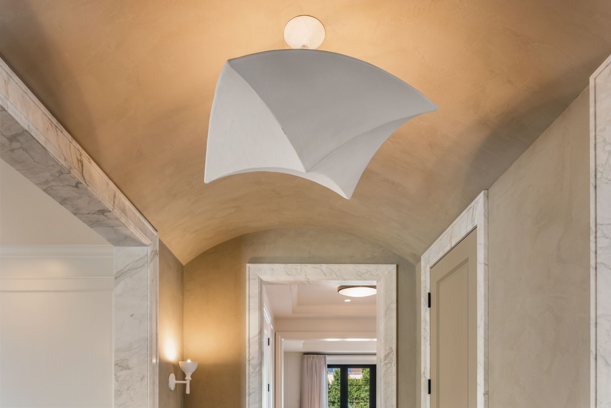 The Thistle House barrel-vaulted entry ceiling with sculptural sconce