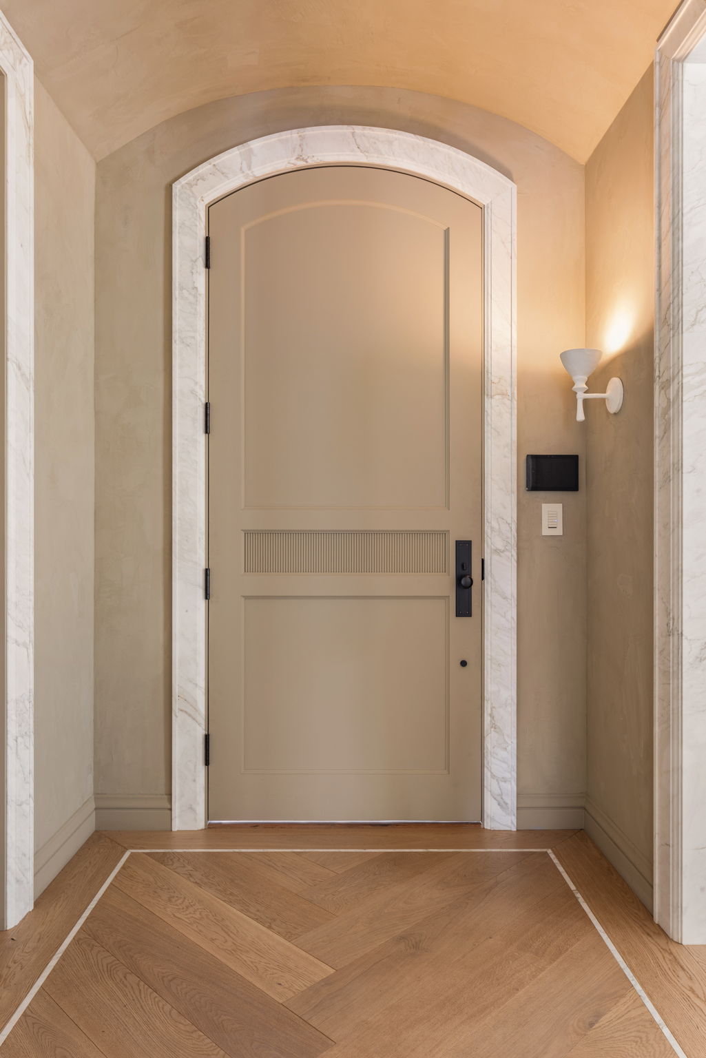 The Thistle House arched entry door with marble surround