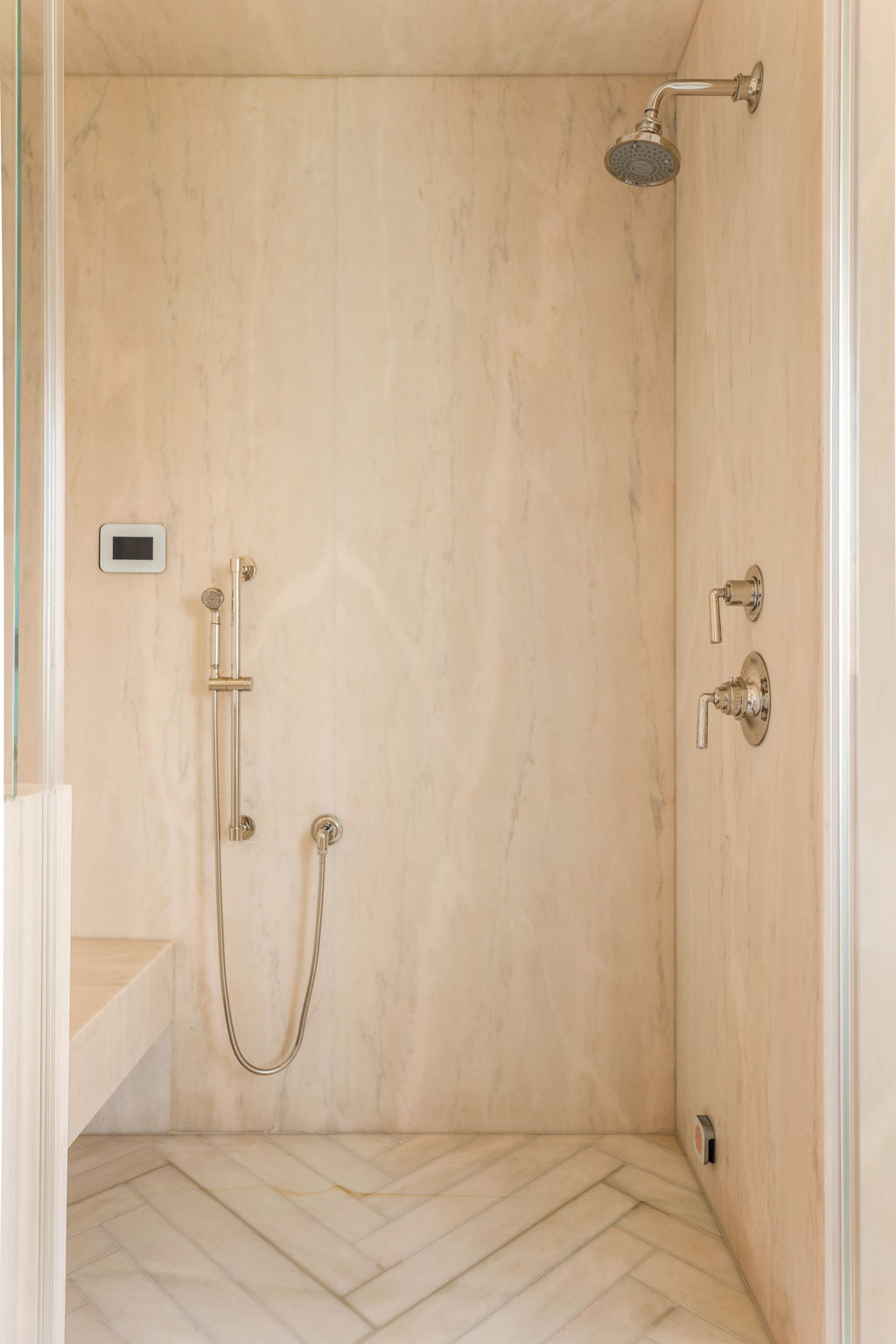 The Thistle House primary bath shower with herringbone marble floor