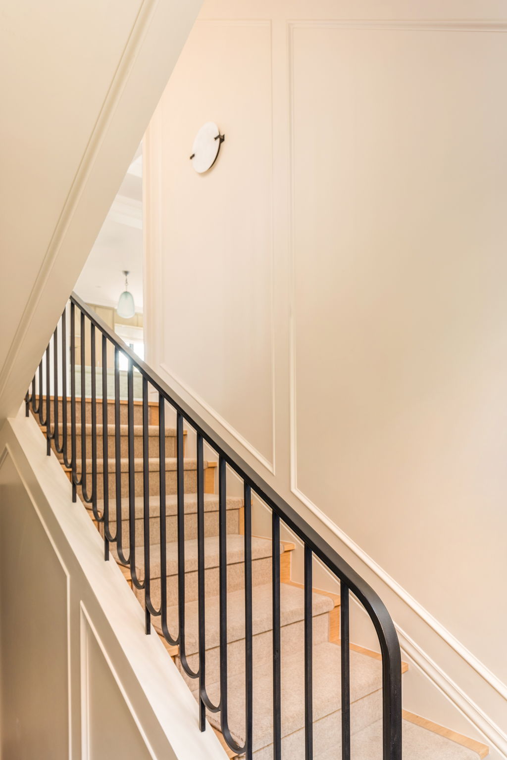 The Thistle House staircase with black iron railing