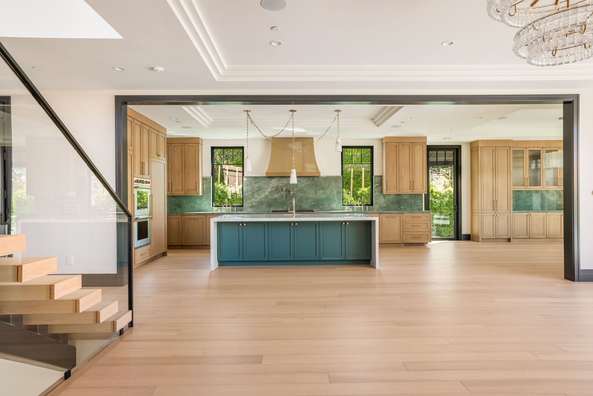 The Verdigris House kitchen wide view with teal island and green quartzite