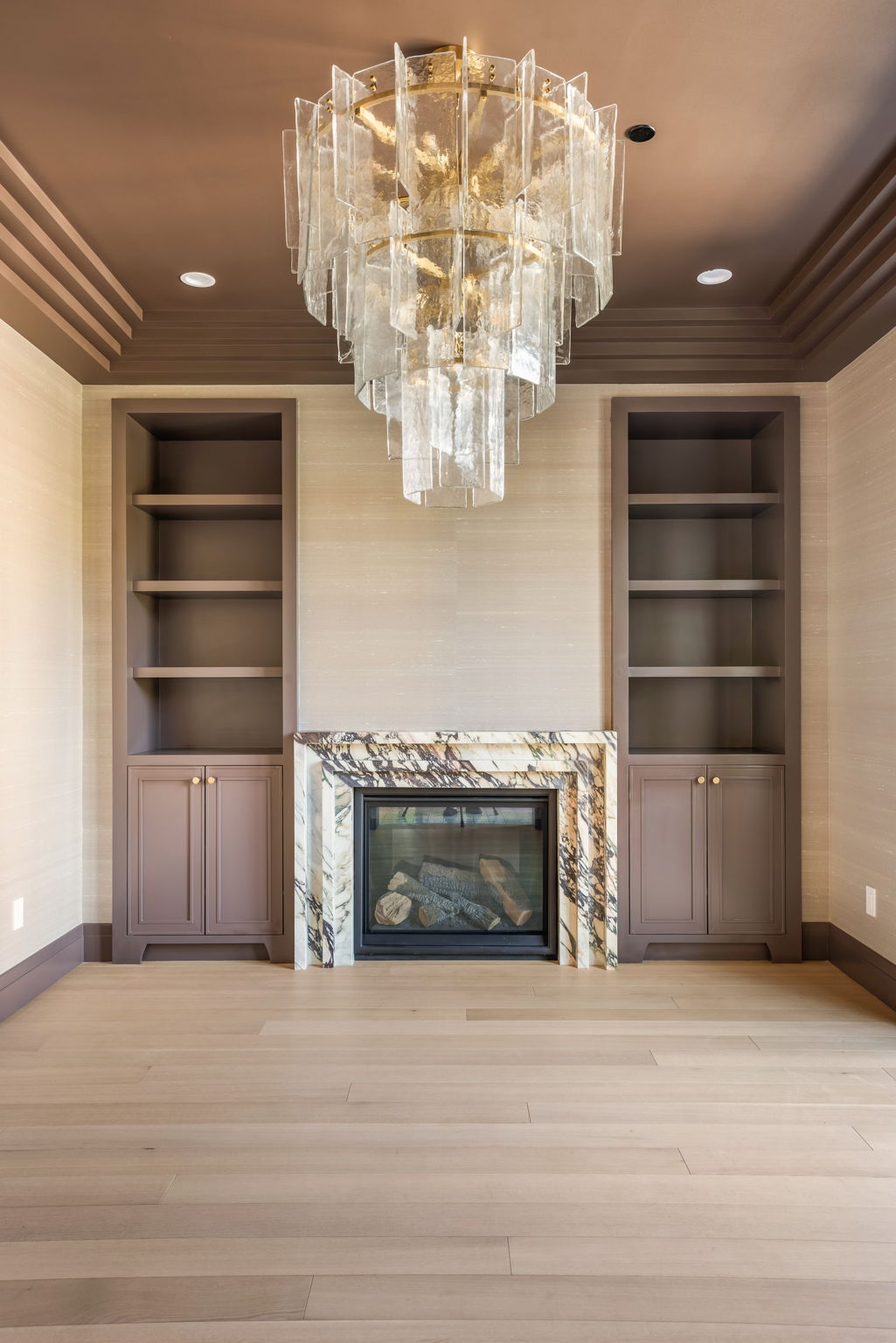 The Verdigris House living room fireplace with marble surround and built-ins