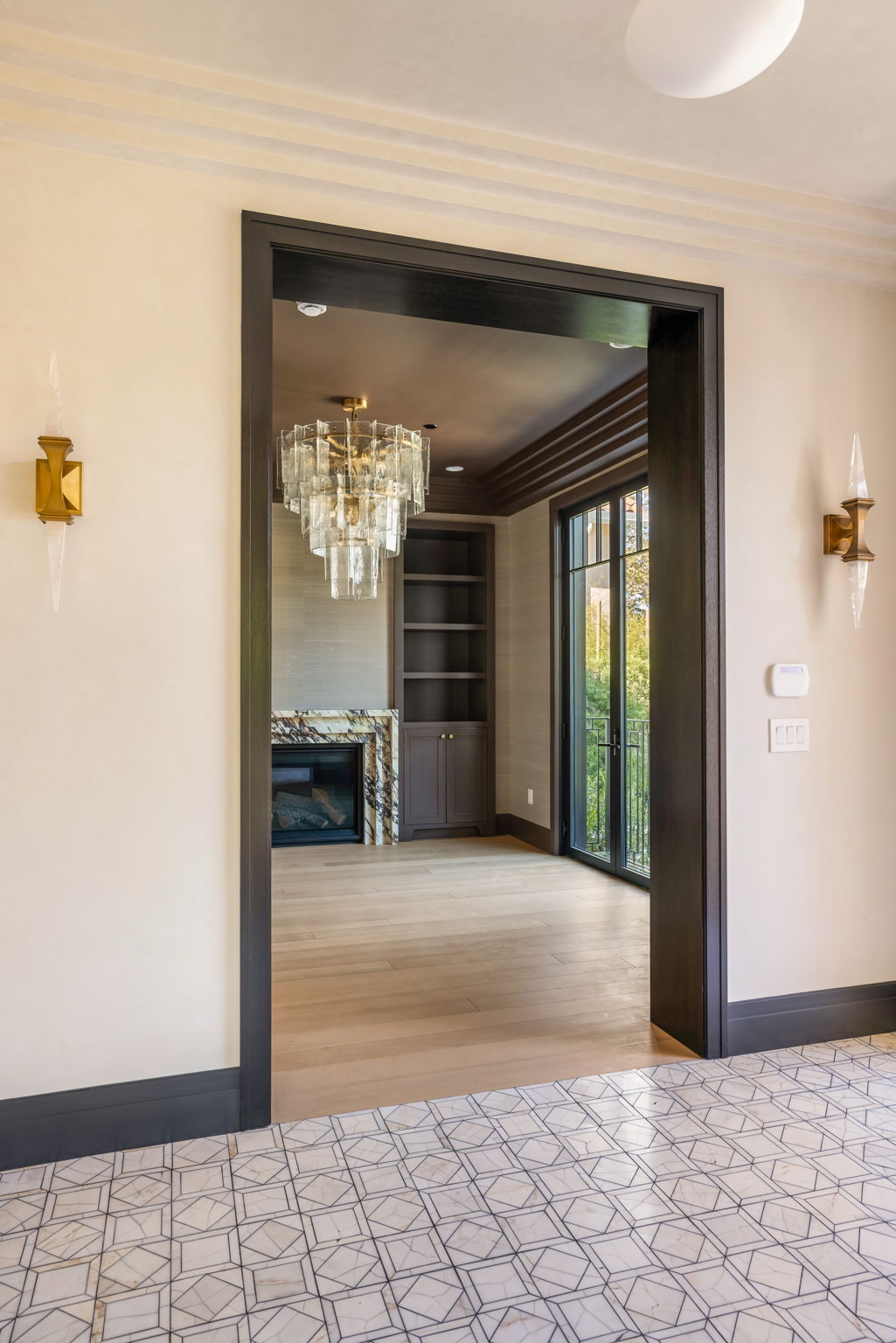 The Verdigris House living room viewed from the entry with statement chandelier