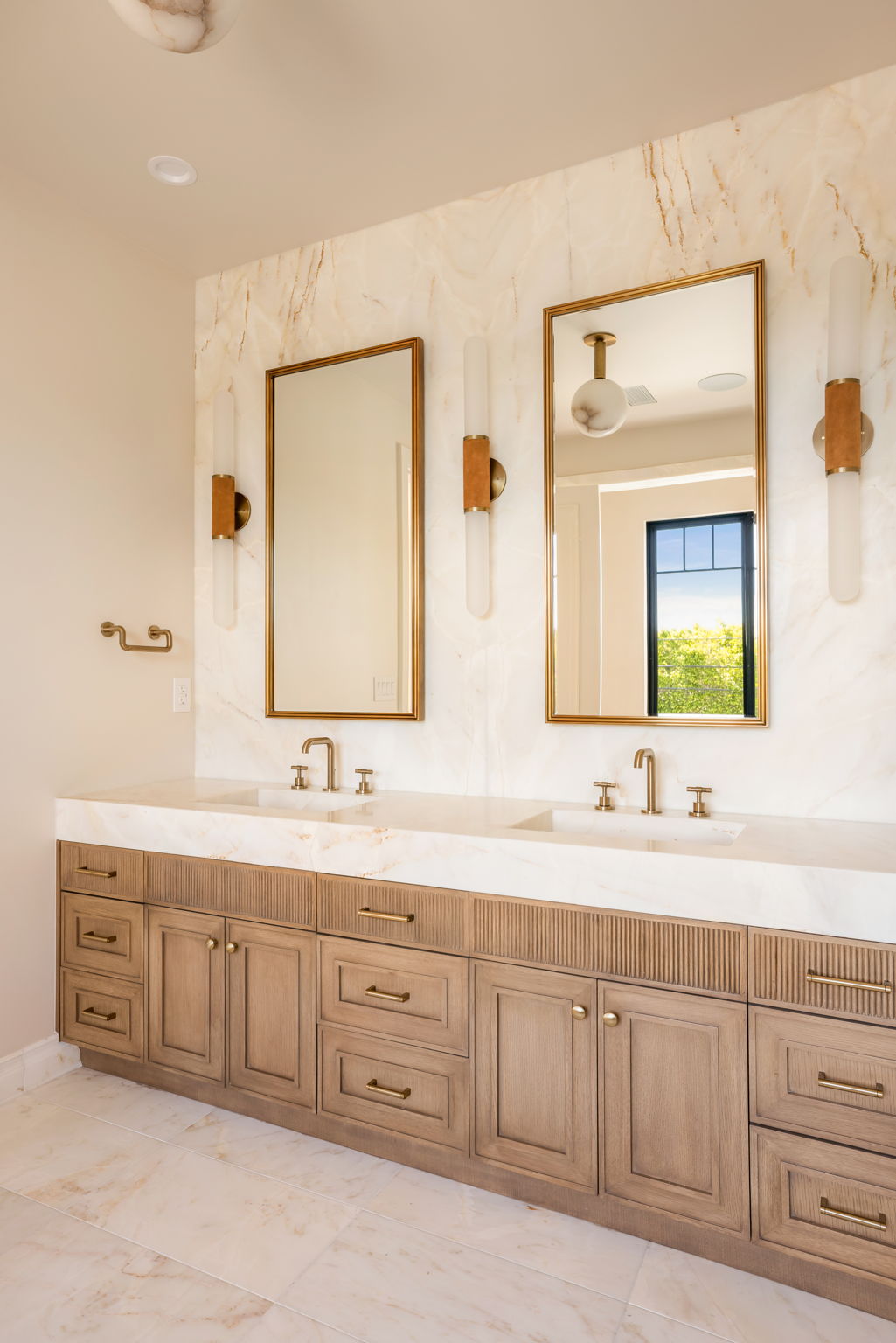 The Verdigris House primary bath vanity wall with full slab marble