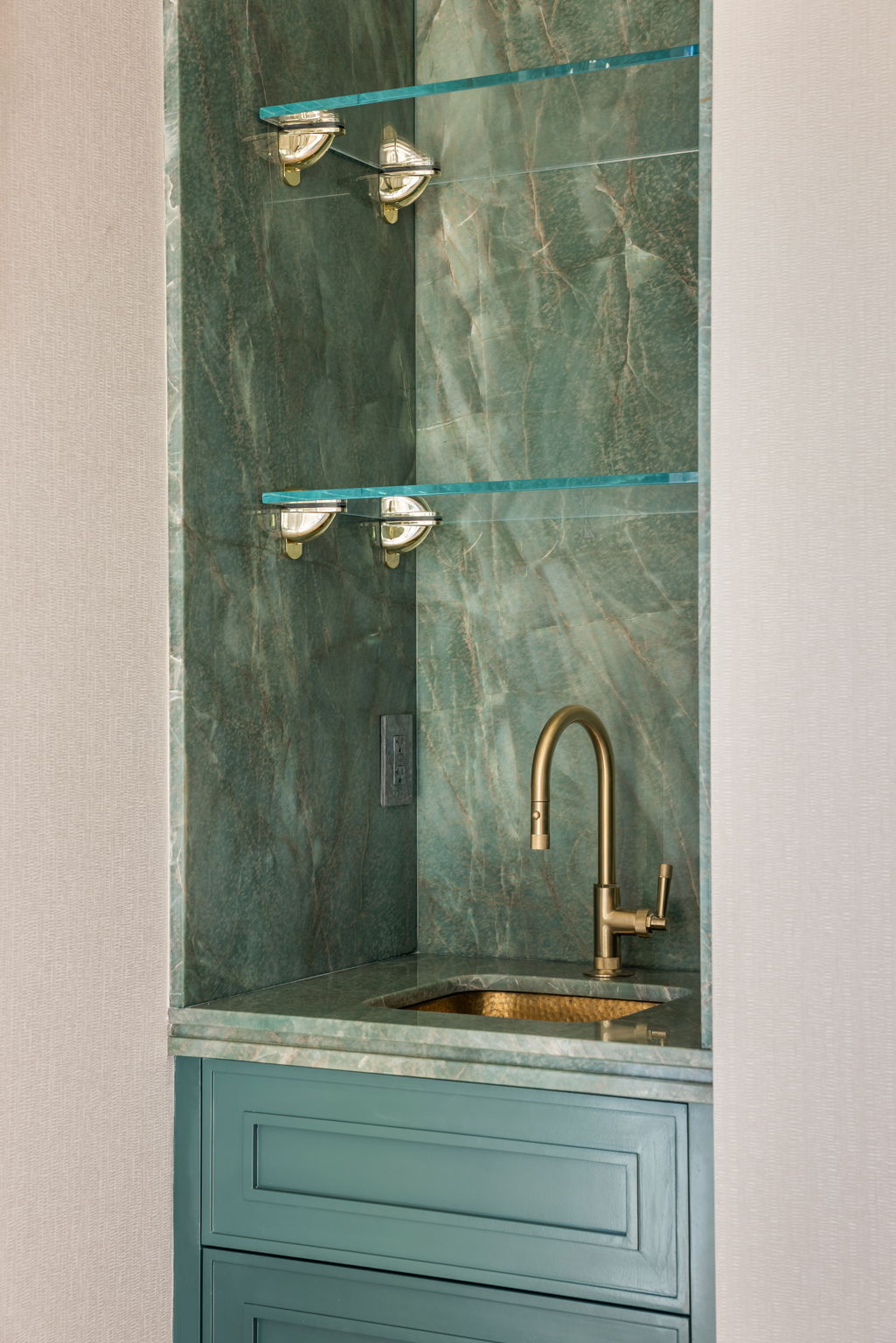 The Verdigris House wet bar with green quartzite surround and brass sink